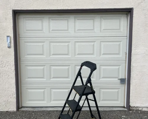 a ladder in front of a garage door
